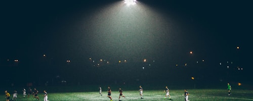 Gaelic football on grass with goalposts in background